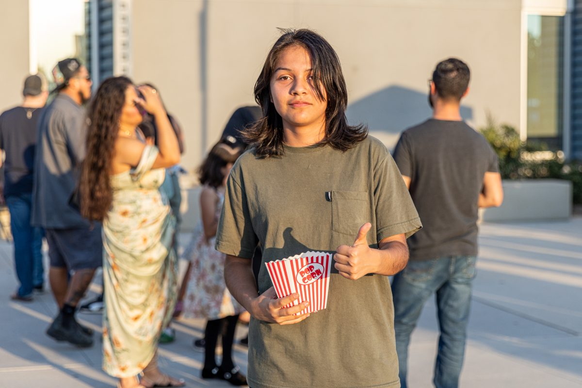 Freshman Esme Gorostieta enjoying popcorn at Fall Festival. (Photo credit: Ellis Evans)