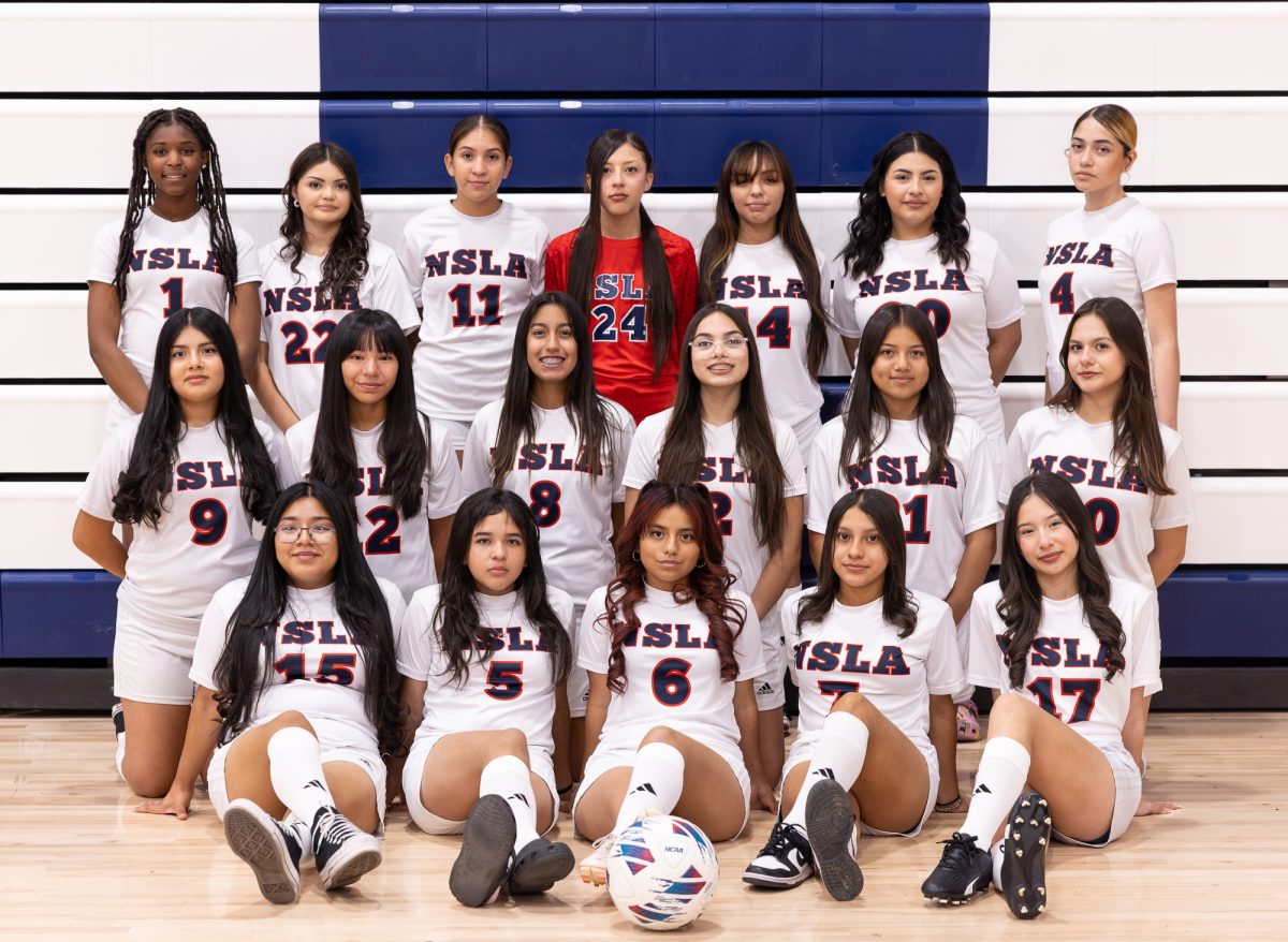 Norton's girls' soccer team poses for a team photo in the gym. (Photo credit: Ellis Evans)