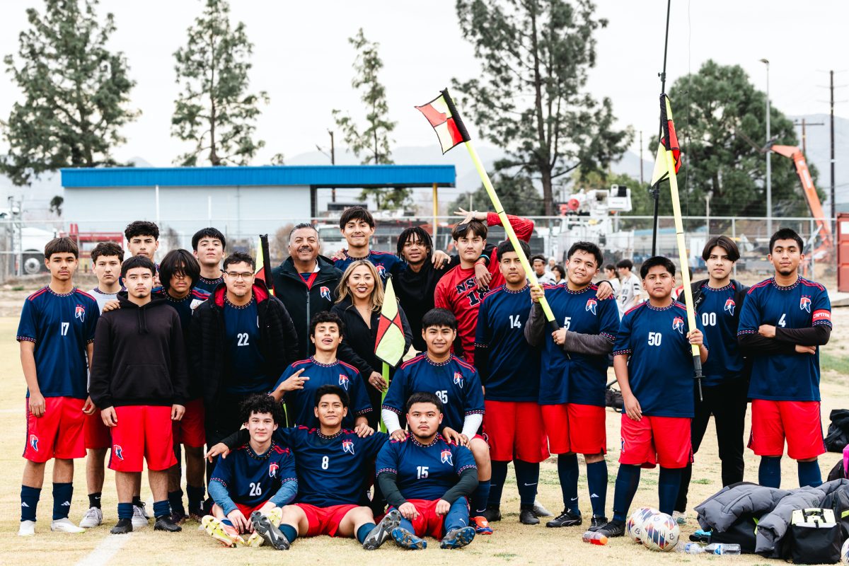 Norton boys soccer team pose for a celebratory group photo after win against United Christian Academy on Thursday, Dec. 12 at the Norton field. (Photo credit: Ellis Evans)