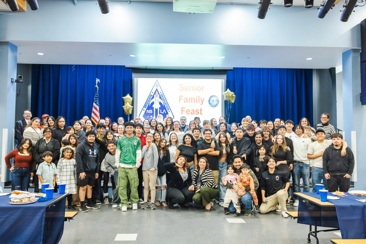 Senior students, staff, and families gather for a group photo at the senior feast on Wednesday, Nov. 20. (Photo credit: Nicole Jaramillo)