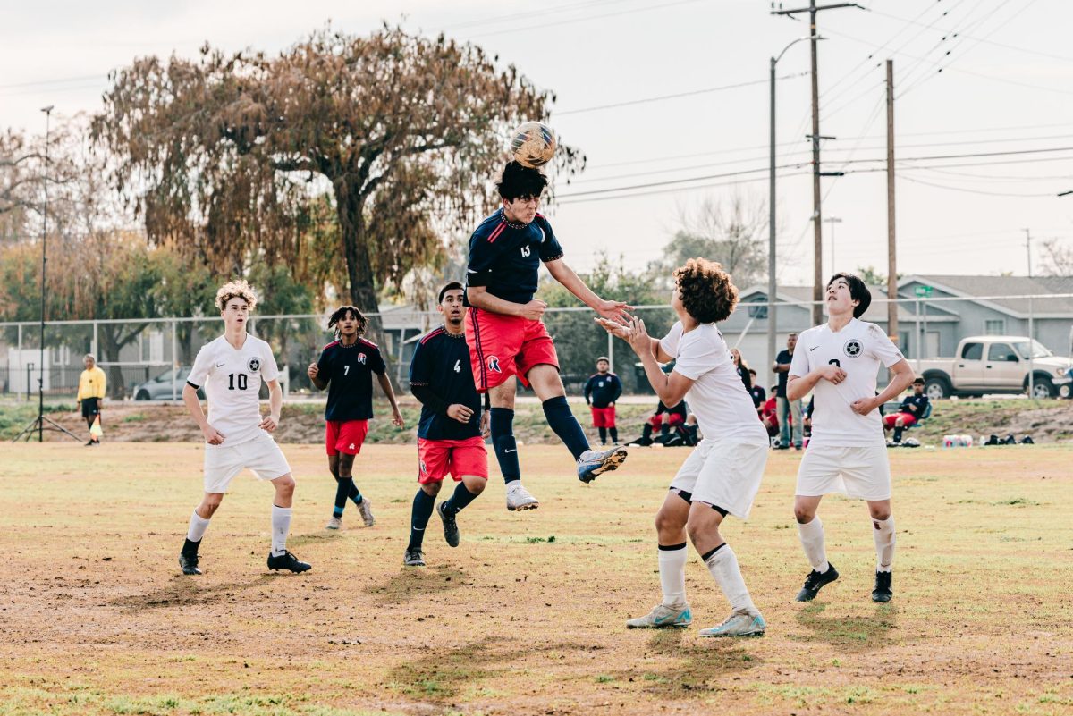 Jacob Zepeda ('25) heads the ball toward team members in Norton's historic CIF championship match against New Roads School at Norton's field on Monday, Feb. 18, 2025. (Photo credit: <a href=