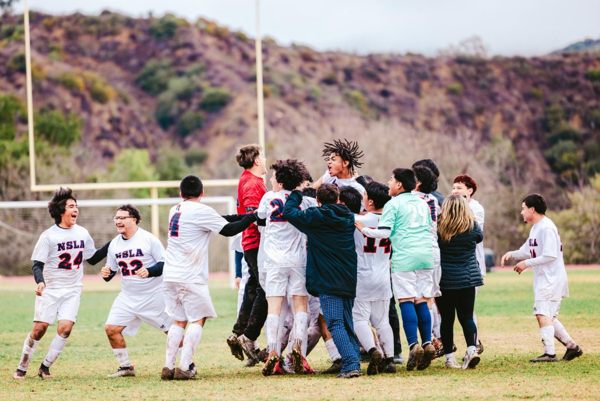 Norton's varsity boys' soccer team cheers after beating Villanova Prep with a 2-1 win on Wednesday, Feb. 12. (Photo credit: Ellis Evans)