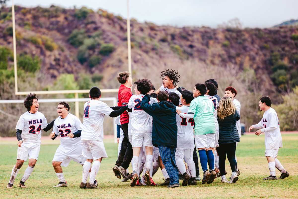 Norton's varsity boys' soccer team cheers after beating Villanova Prep with a 2-1 win on Wednesday, Feb. 12. (Photo credit: Ellis Evans)