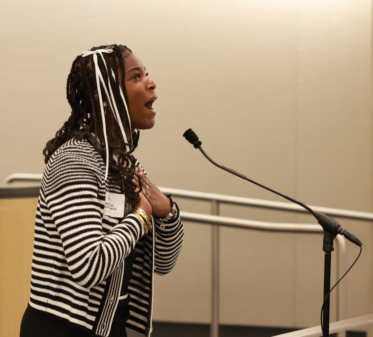 Toochi Samsylvanus ('27) delivers her final poem, "a song in the front yard" by Gwendolyn Brooks at the 2025 California Poetry Out Loud Finals on Mar. 17, 2025. Samsylvanus' ('27) recitation marks the end of the second day's final round held at the State Capitol Annex Swing Space. Each student reciter was required to recite three poems that met the requirements from Poetry Out Loud . The requirements for the three poems are: 1) one poem must be 25 lines or fewer, 2) one poem must be written before the 20th century, and 3) one poem may be used to meet the first two criteria and be the student's final poem. Samsylvanus' ('27) three poems were: 1) "Shall earth no more inspire thee" by Emily Brontë, 2) "No Coward Soul is Mine" by Emily Brontë, and 3) "a song in the front yard" by Gwendolyn Brooks. (Photo courtesy of David Tellyer.) 